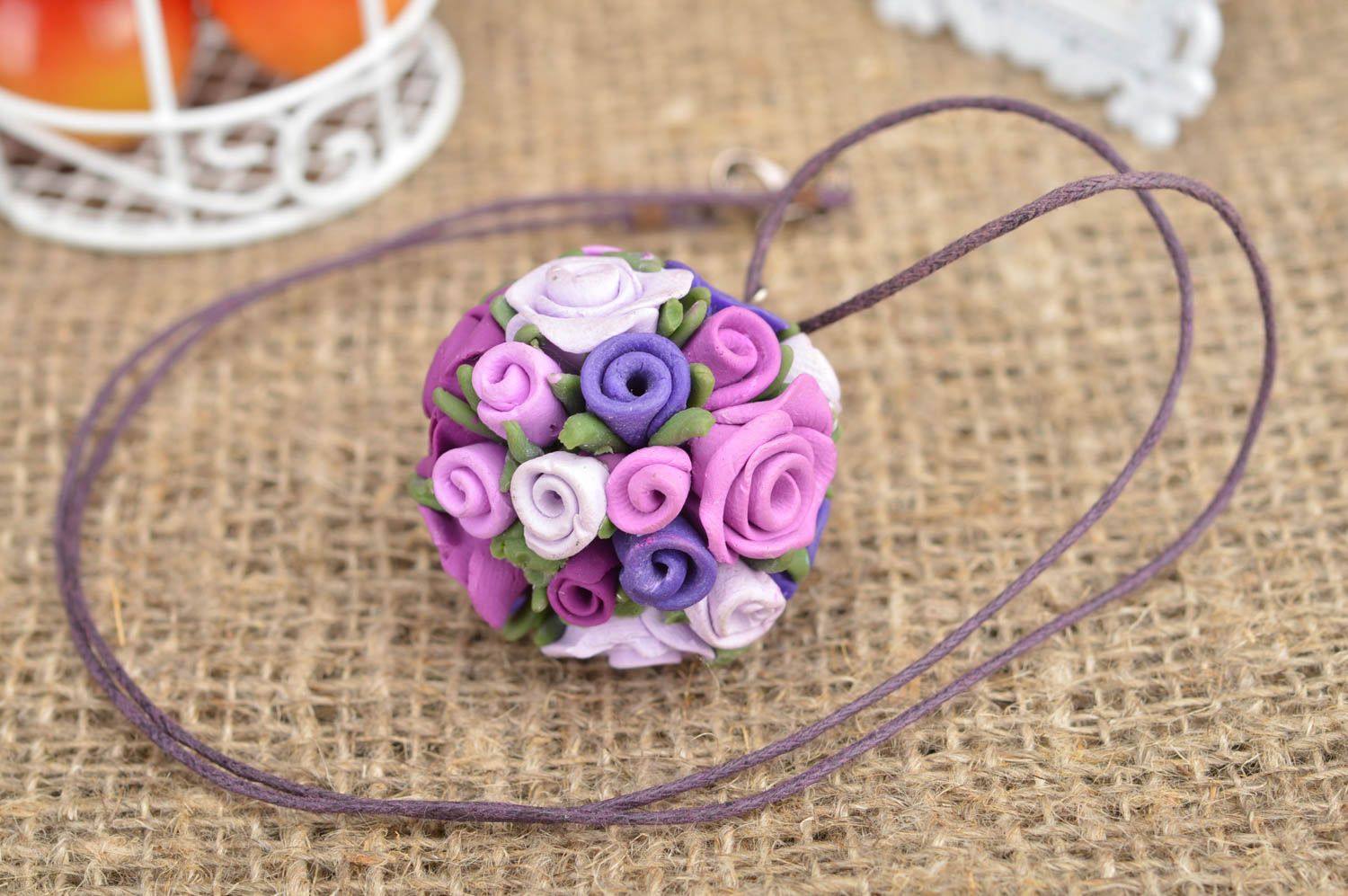 Handmade pendant made of polymer clay in form of purple flowers on cord photo 1
