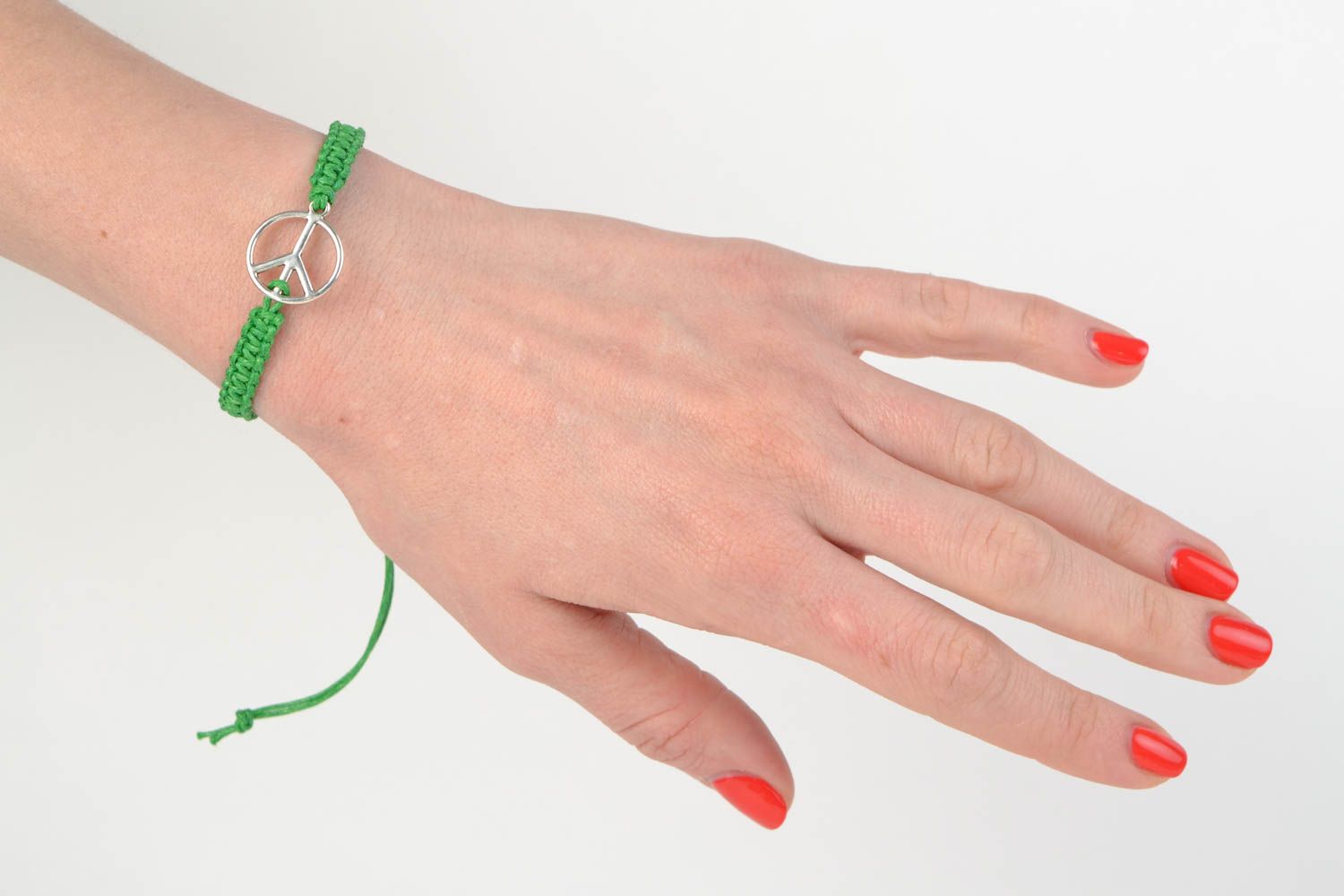 Green handmade woven cotton cord wrist bracelet with metal charm photo 2