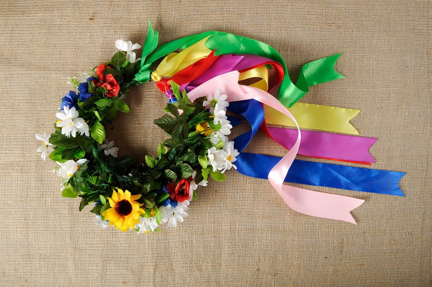 Wreath with artificial flowers and ribbons photo 4