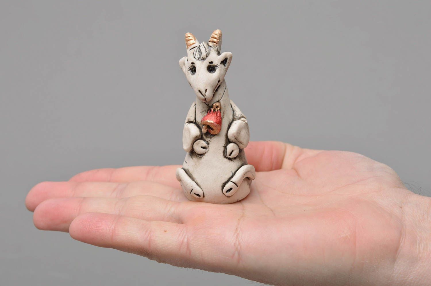 Handmade designer small white glazed porcelain figurine of goat with red bell photo 4