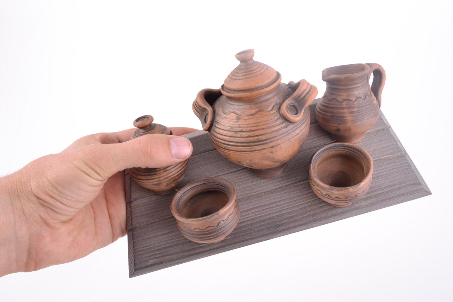 Ethnic handmade wall panel in the shape of wooden board with clay dishware photo 2