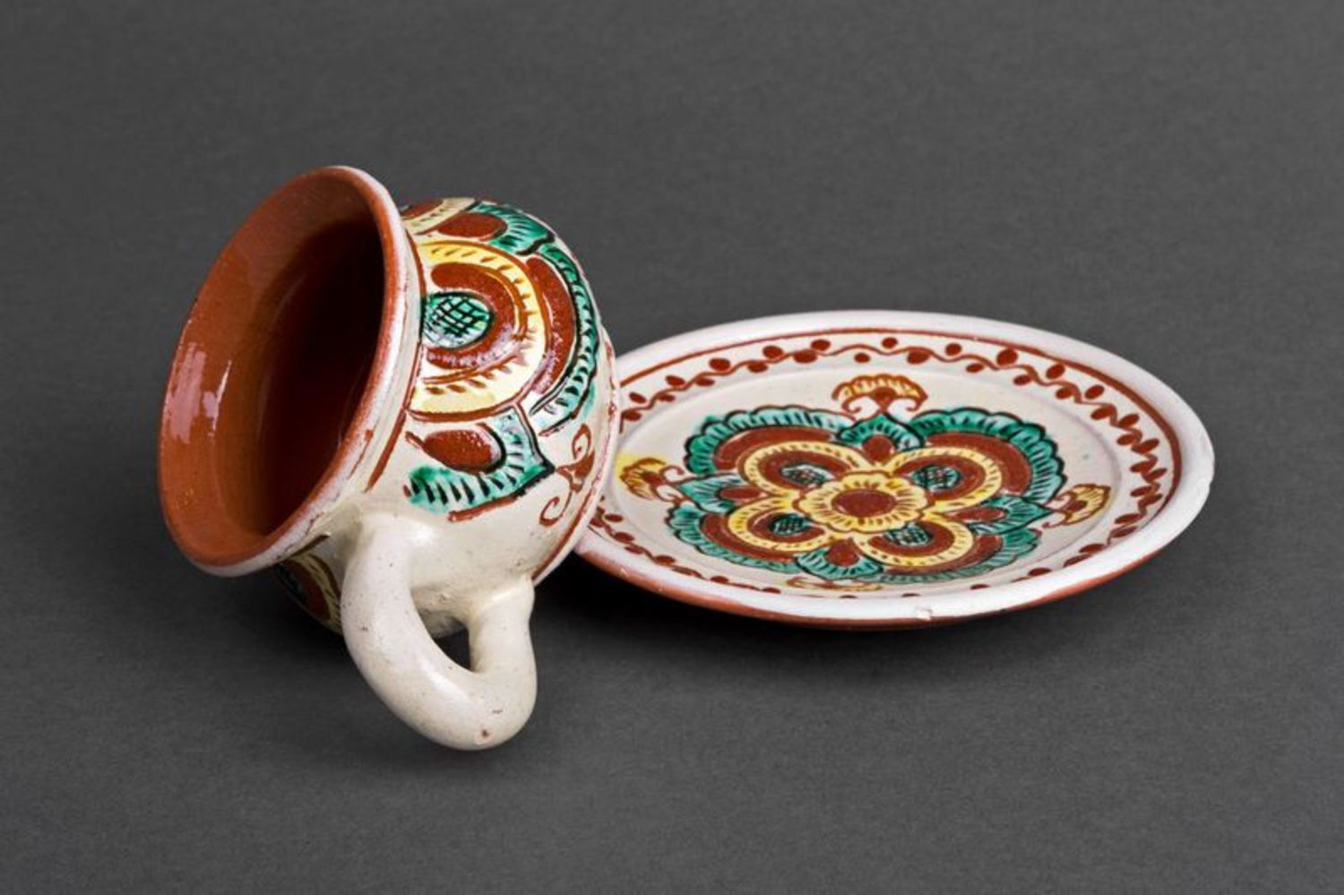 Rustic style clay coffee cup with handle and saucer with Ukrainian style brown and green color pattern photo 3