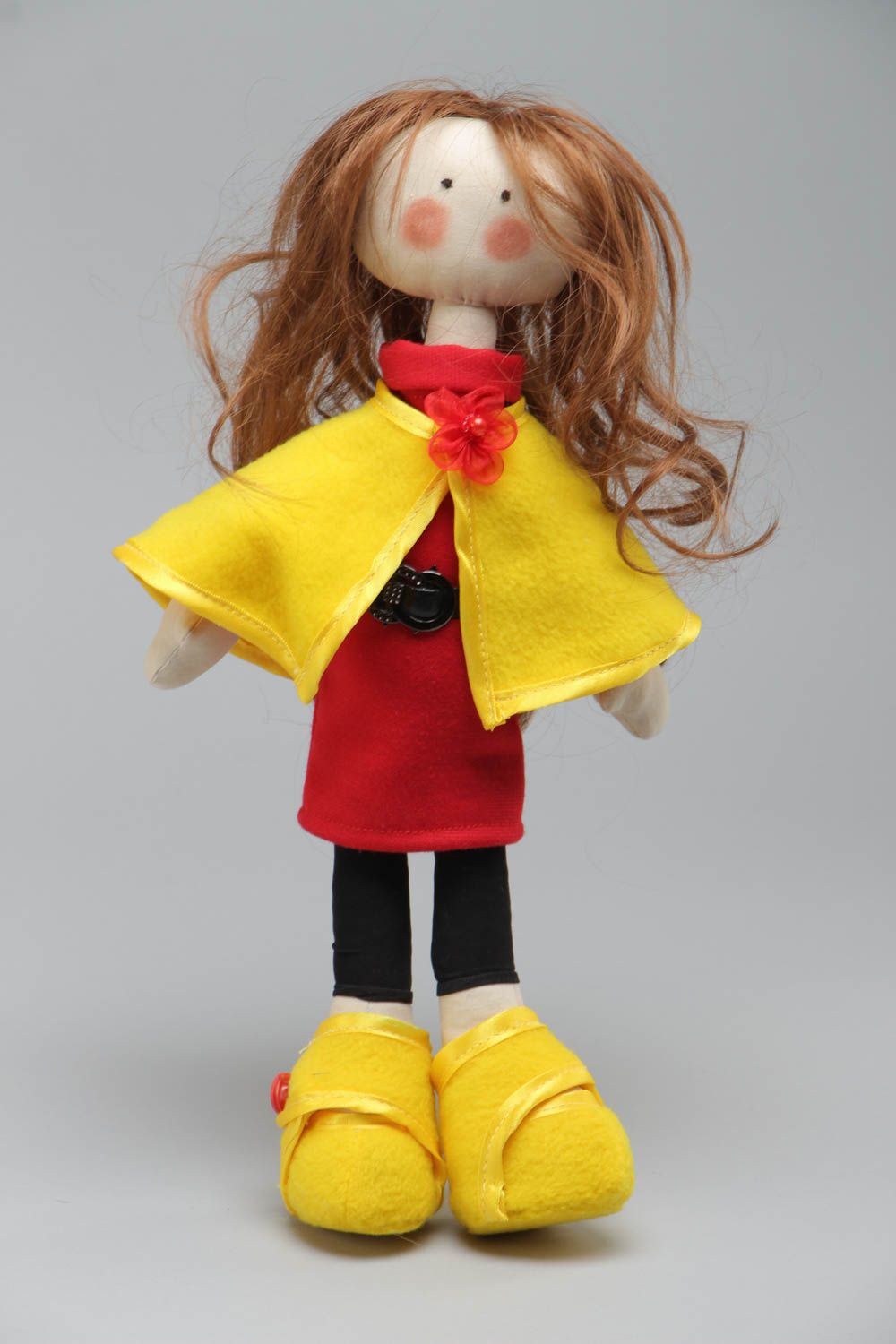 Handmade soft doll sewn of cotton fabric in yellow coat and shoes for children photo 2