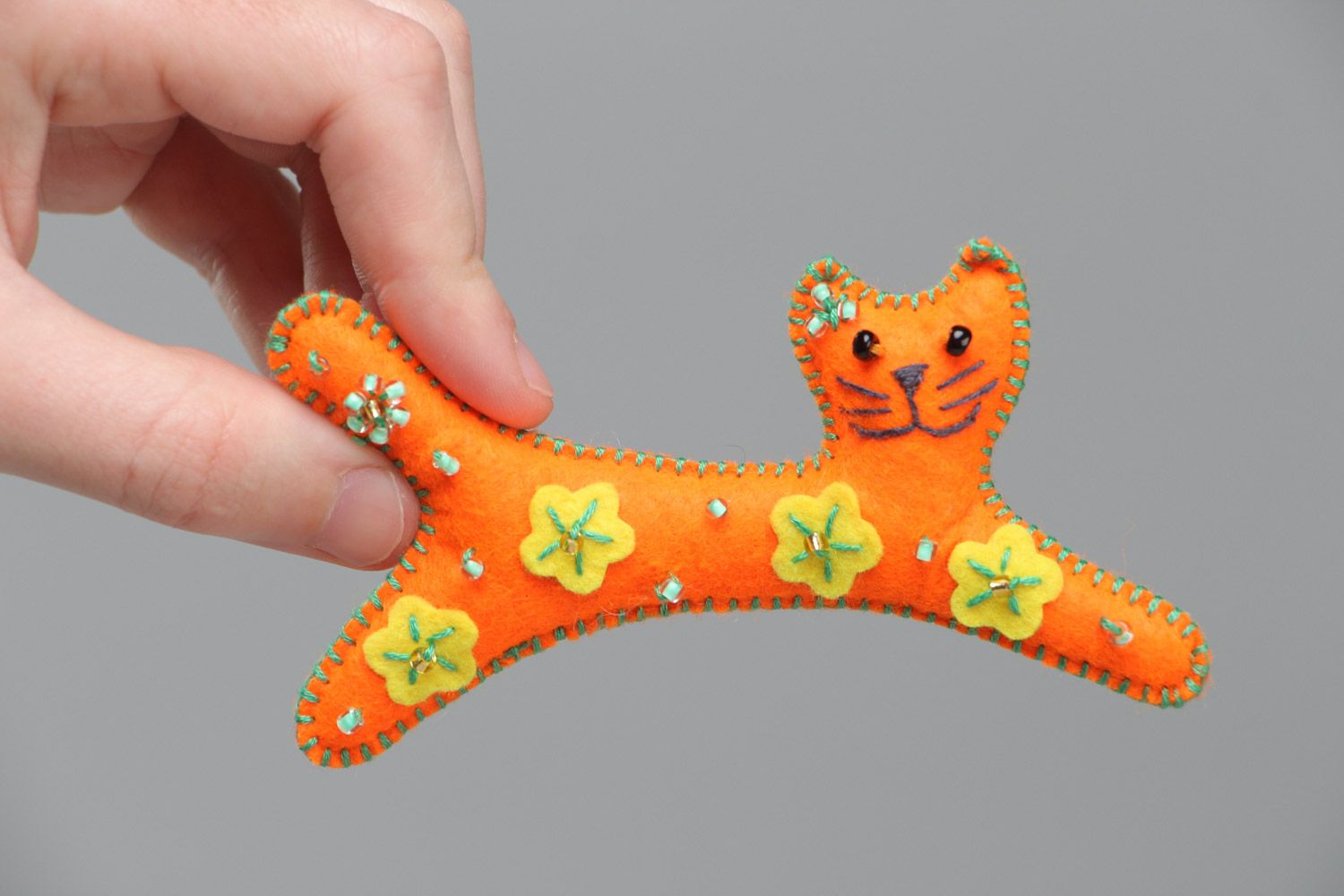 Handmade small soft toy sewn of felt in the shape of long orange kitten  photo 5