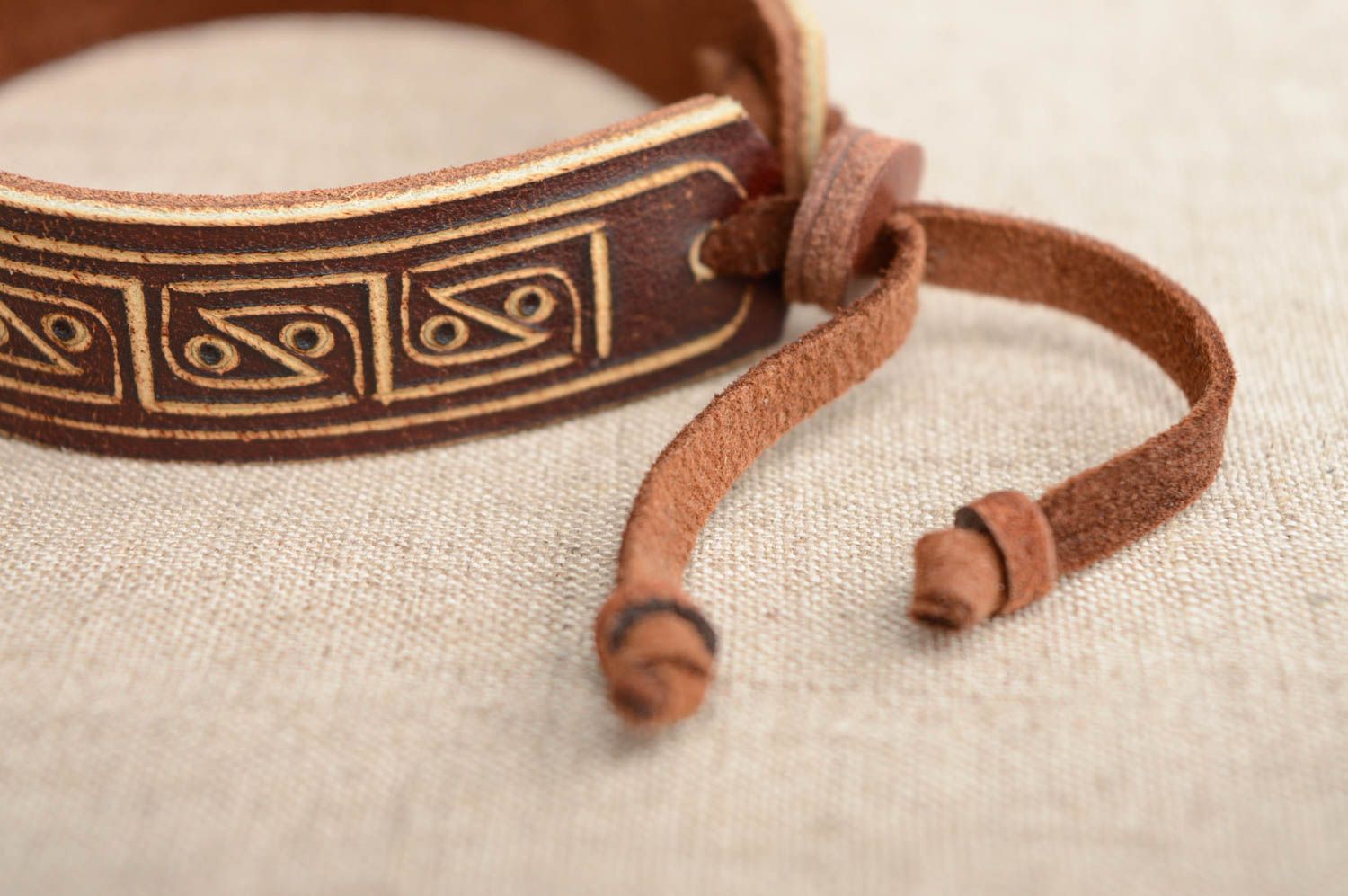 Carved leather bracelet with ties photo 3