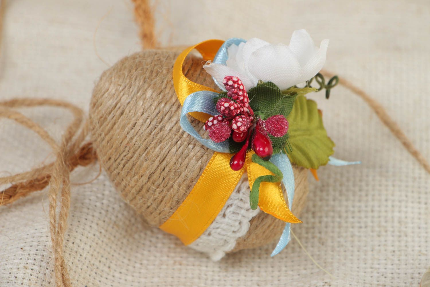 Handmade small decorative souvenir Easter egg with lace flowers and cord photo 1