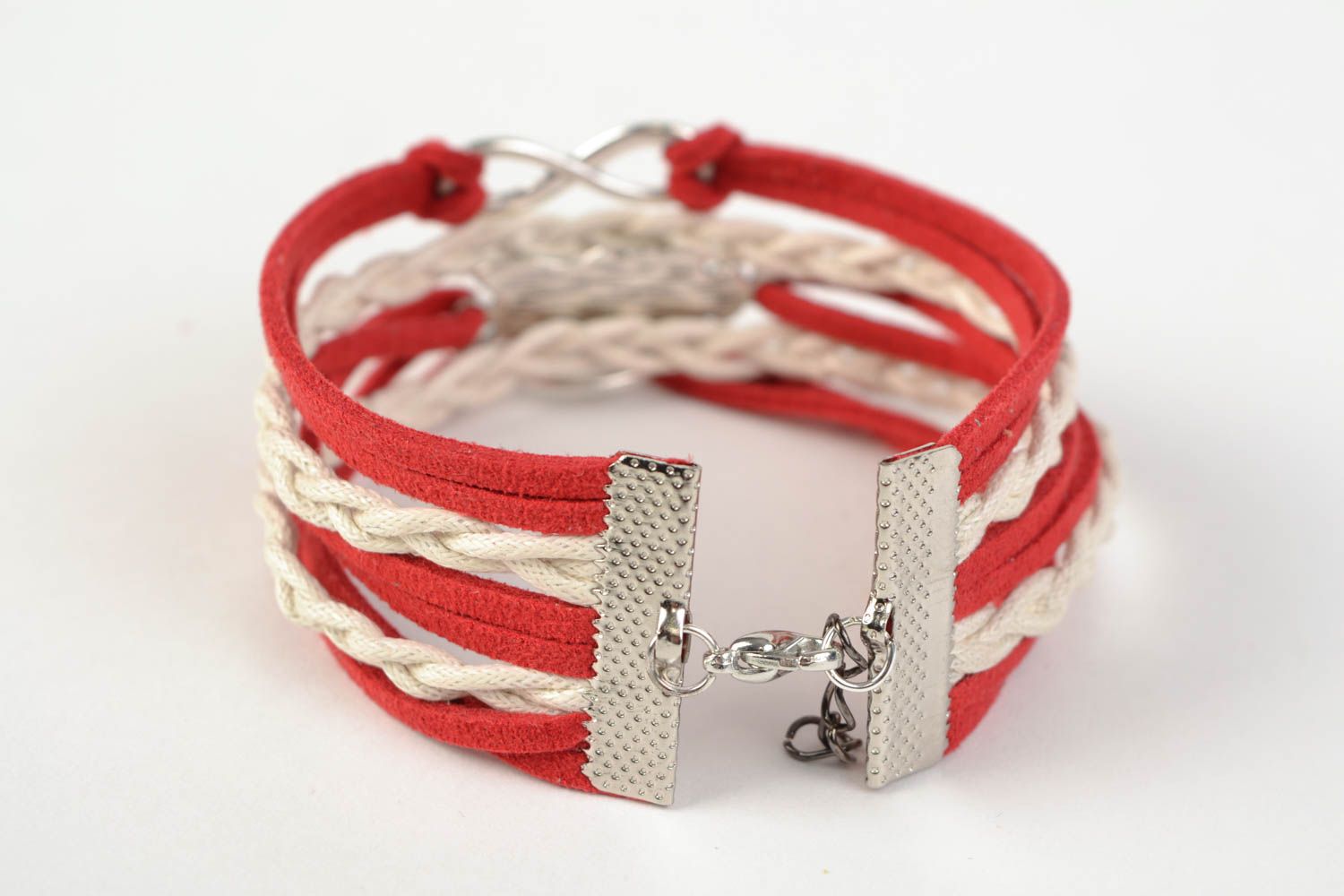 Red handmade woven suede cord bracelet with inserts in the shape of various signs photo 4