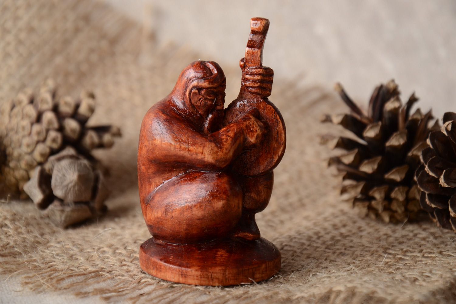 Handmade miniature carved wooden figurine in the shape of Cossack for table decor photo 1