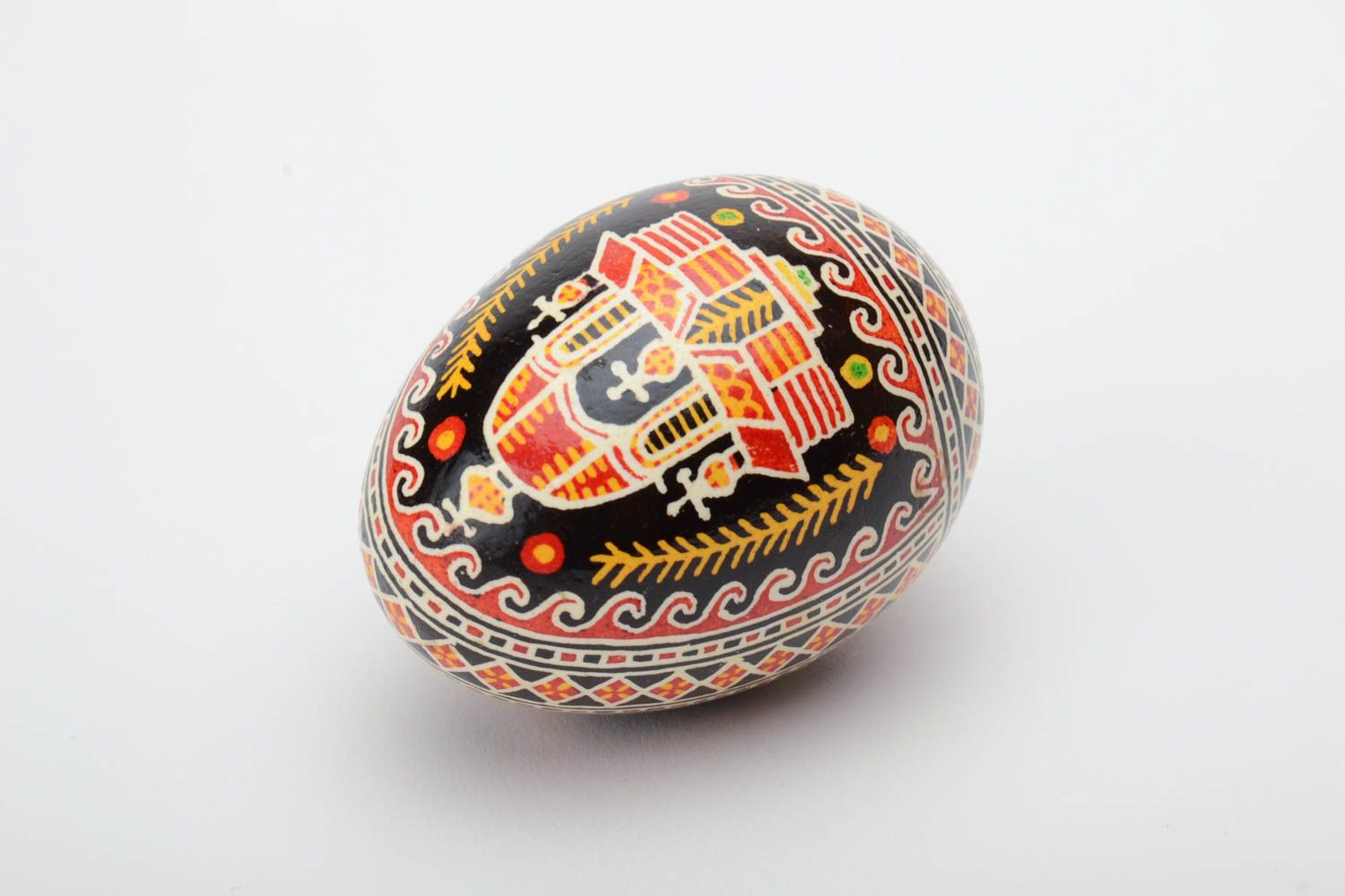 Handmade decorative painted Easter egg with black background and church image photo 2
