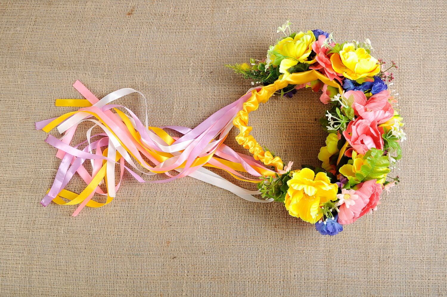 Bright wreath with artificial flowers and ribbons photo 2