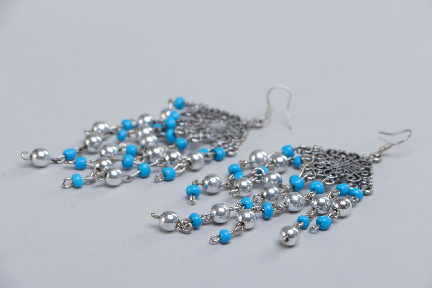Long metal handcrafted earrings made of beads of different sizes photo 3