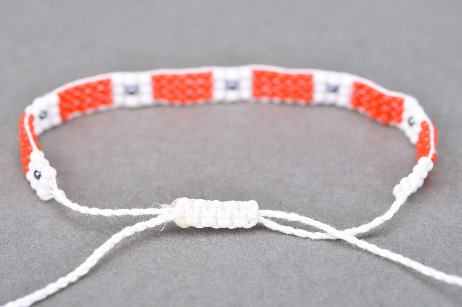 Handmade woven women's thin beaded wrist bracelet of red and white colors photo 5