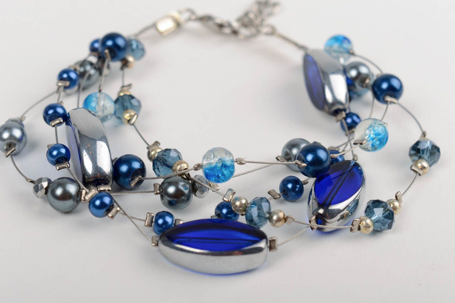 Handmade designer wrist bracelet with dark blue ceramic pearls and crystal beads photo 2
