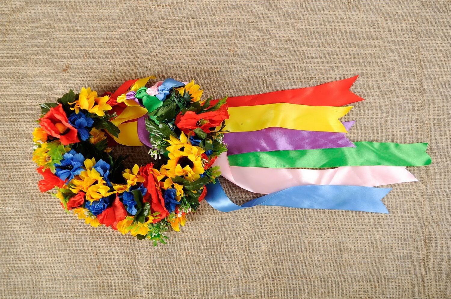 Wreath made of artificial flowers with ribbons photo 1