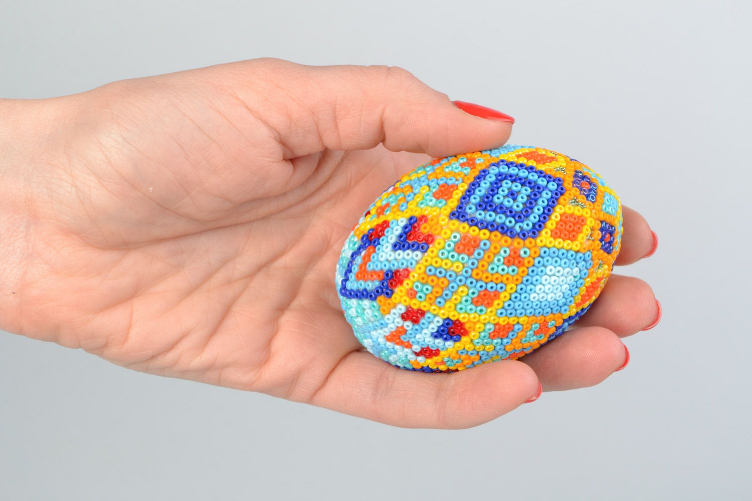 Handmade wooden multicolored Easter egg braided over with beads in Huichol style photo 2