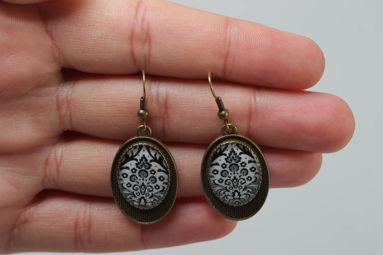 Handmade vintage metal earrings of oval shape with patterns coated with glaze photo 5