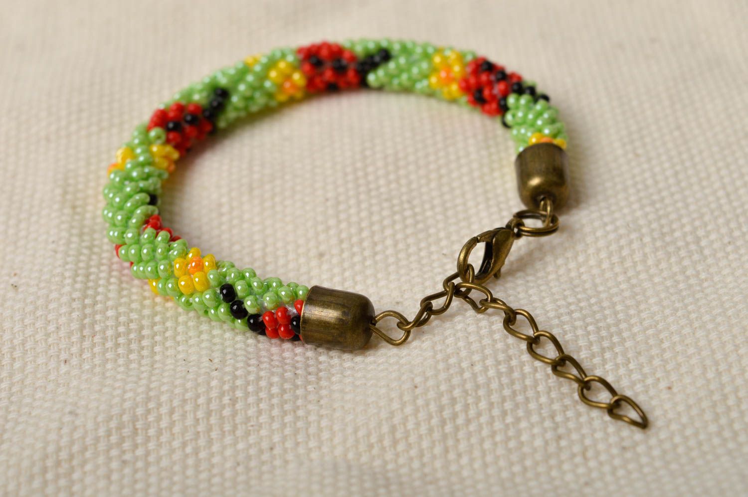 Handmade beaded cord adjustable bracelet in light green, red and black color photo 1