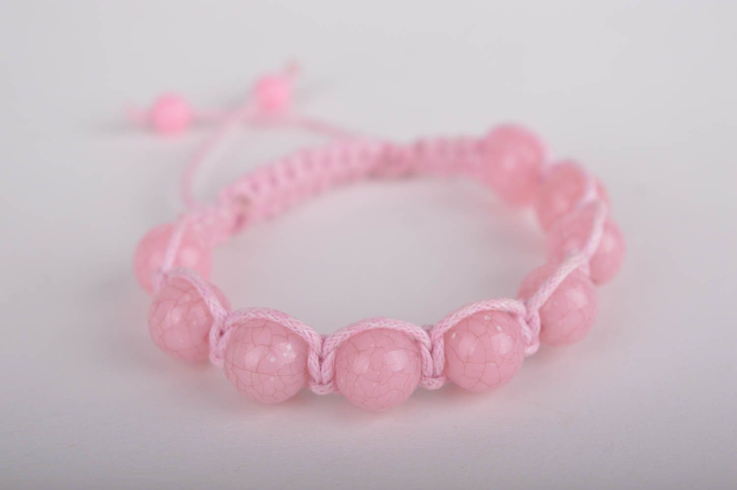 Light pink strand bracelet with pink cord and pink beads photo 1