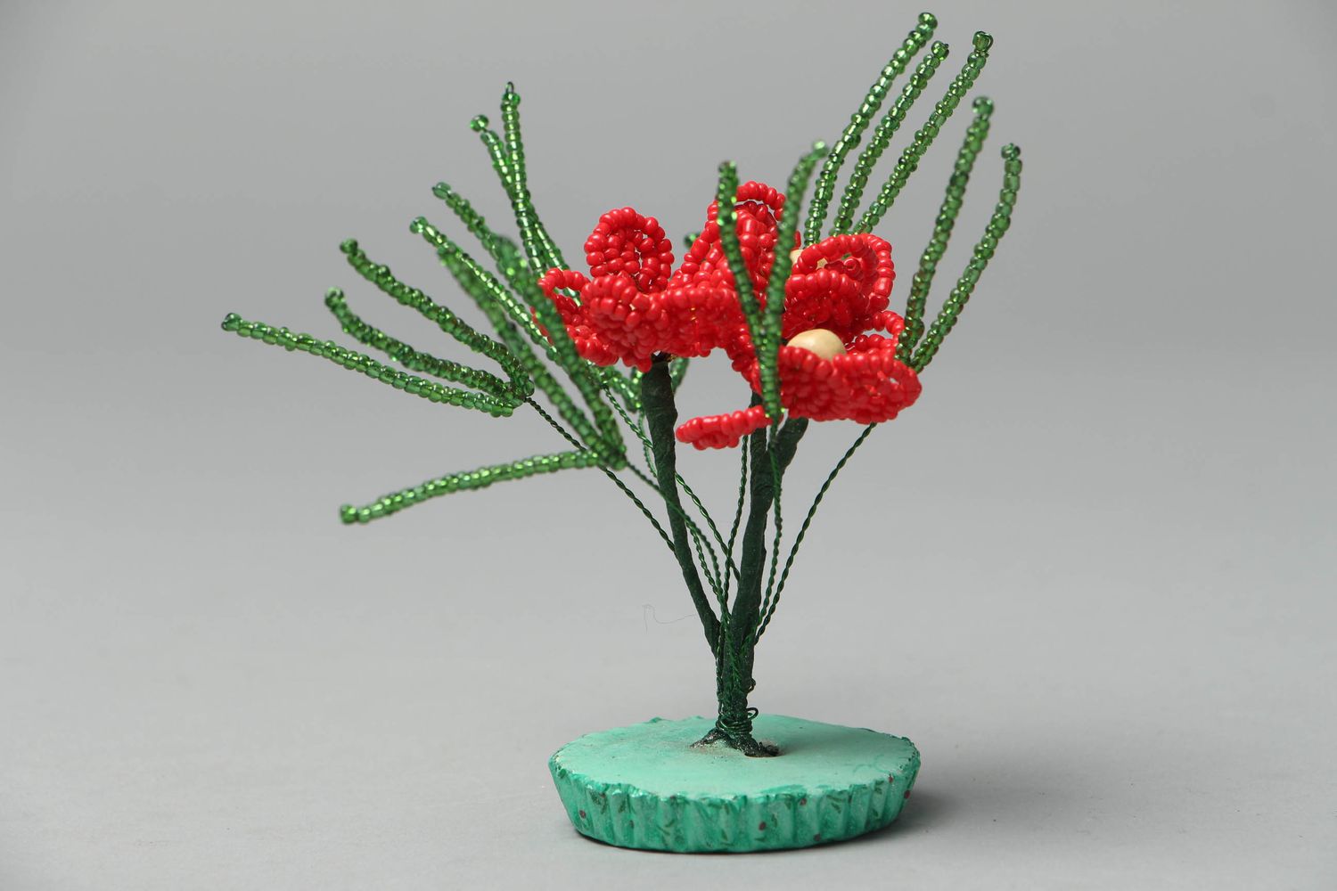 Decorative beaded flower composition of red color photo 1