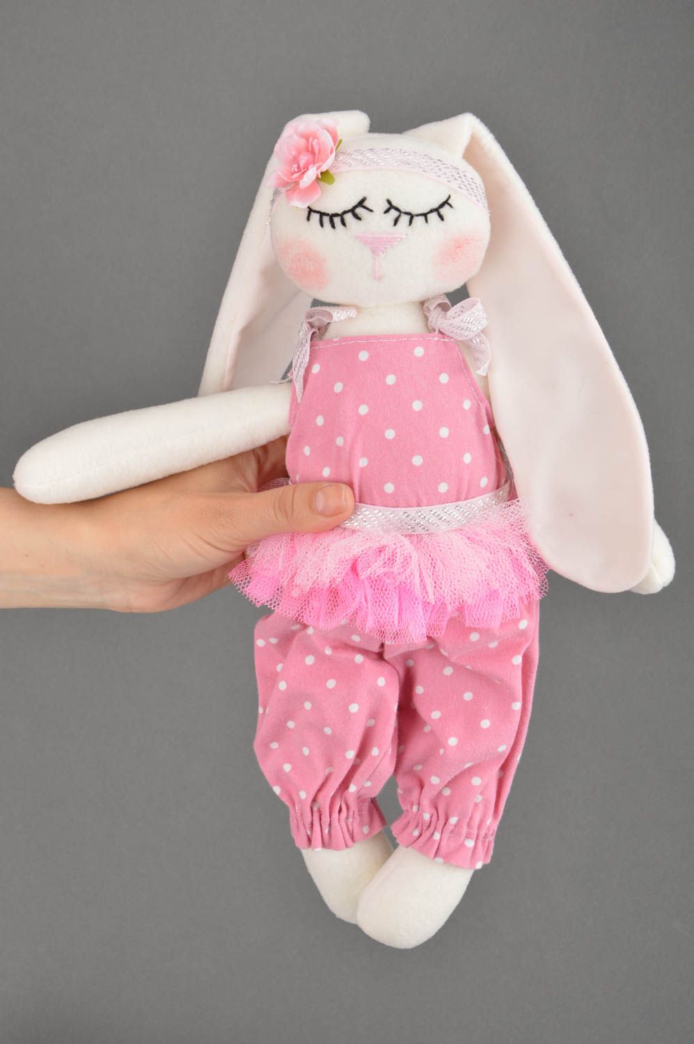 Handmade soft toy sewn of cotton fabric rabbit in pink clothing for children photo 3