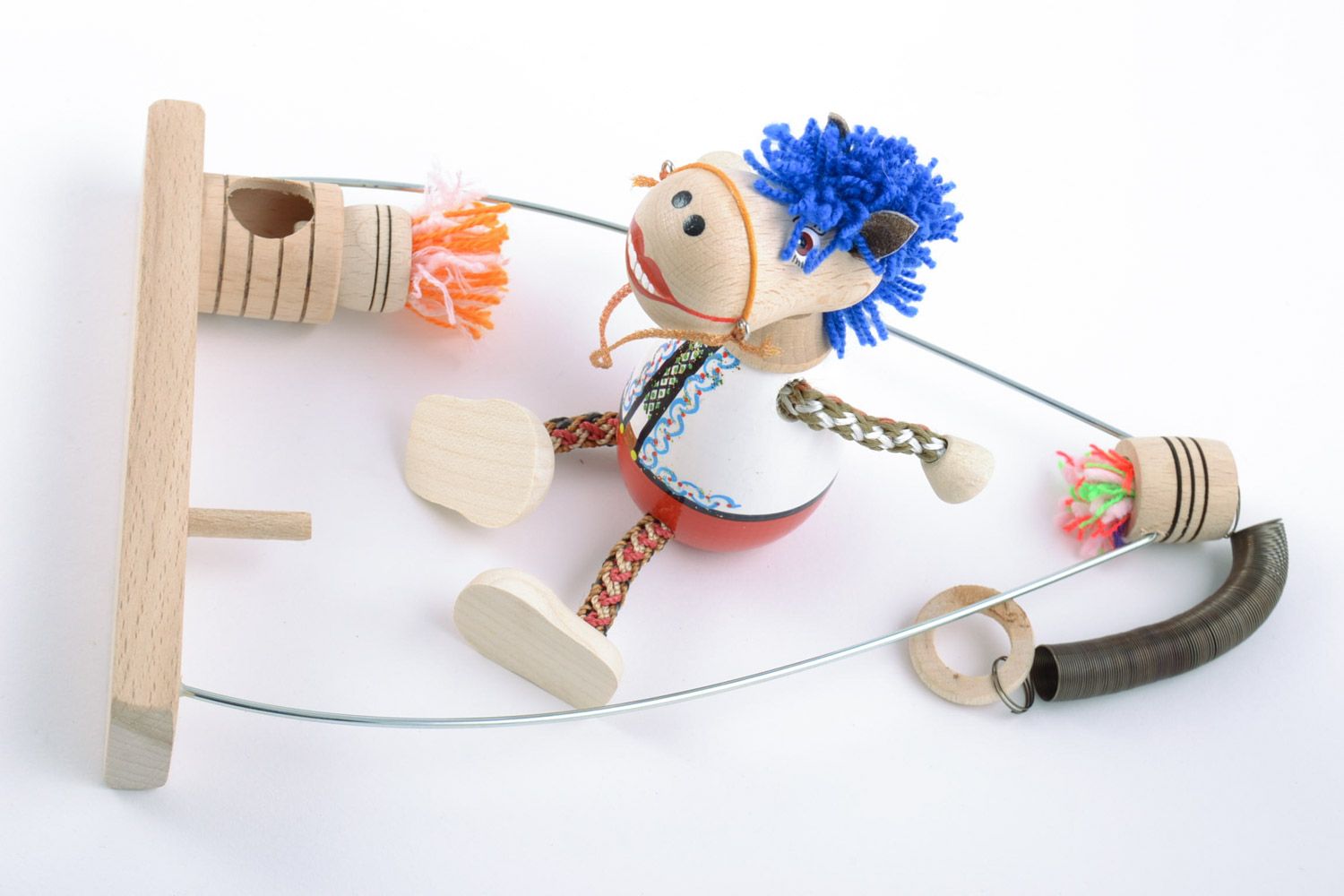 Handmade wooden eco toy with painting horse in folk costume on swing photo 5
