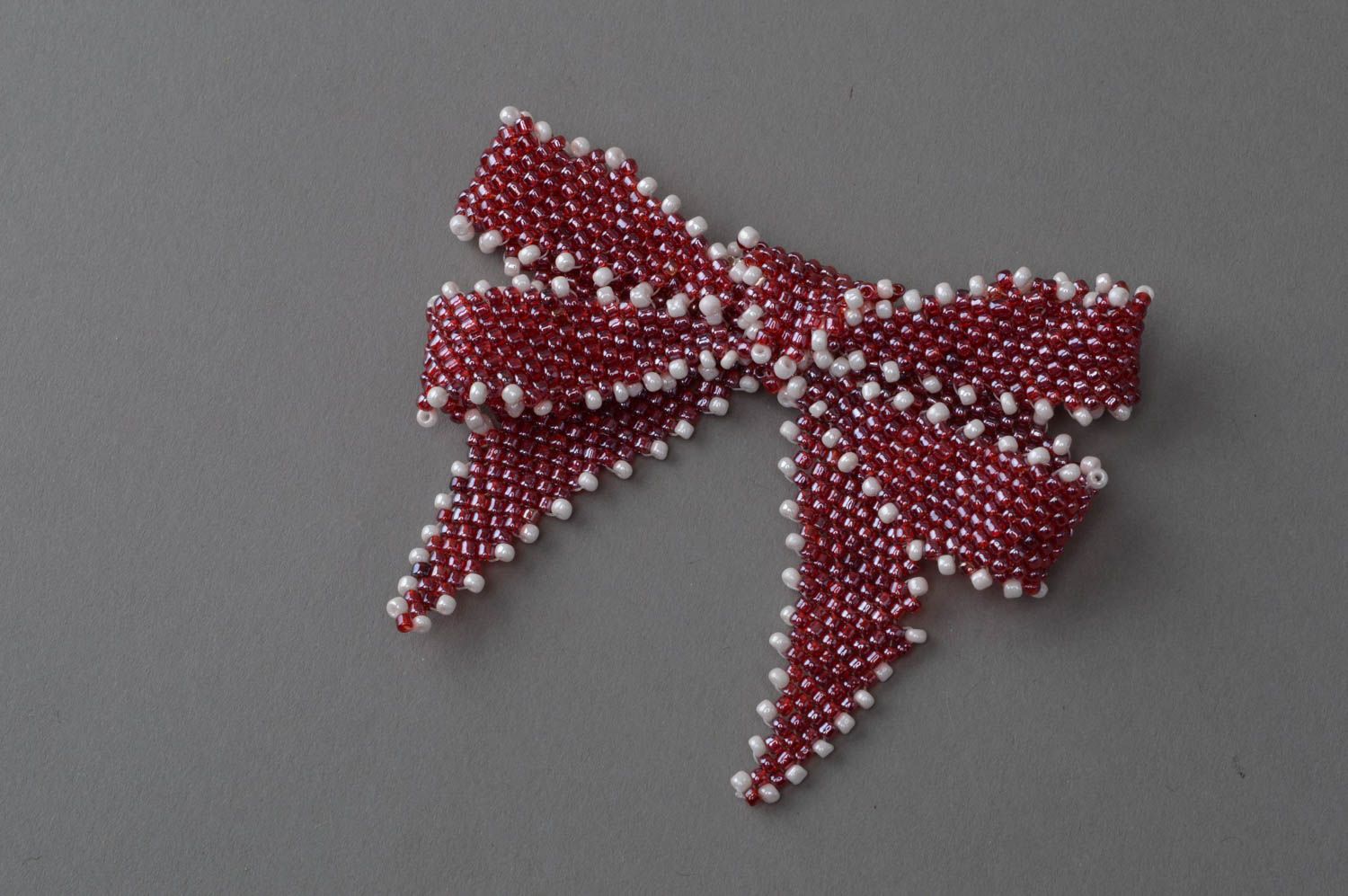 Small handmade brooch in the form of a bow made in red color with white accents photo 2