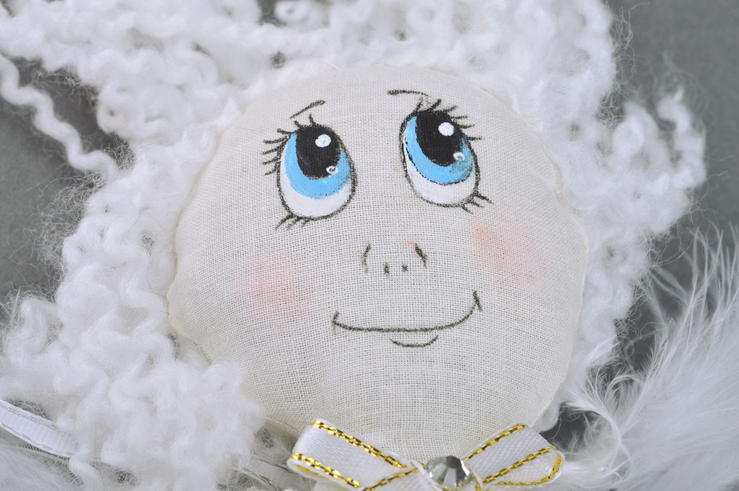 Handmade white fabric soft doll of average size with wings made of feathers photo 4