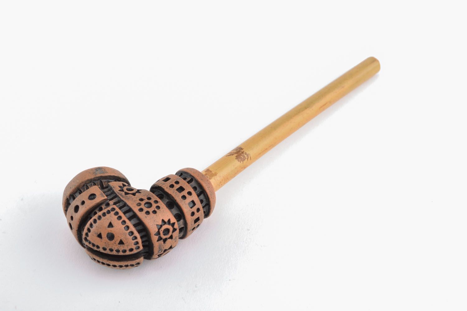 Clay smoking pipe in ethnic style photo 2