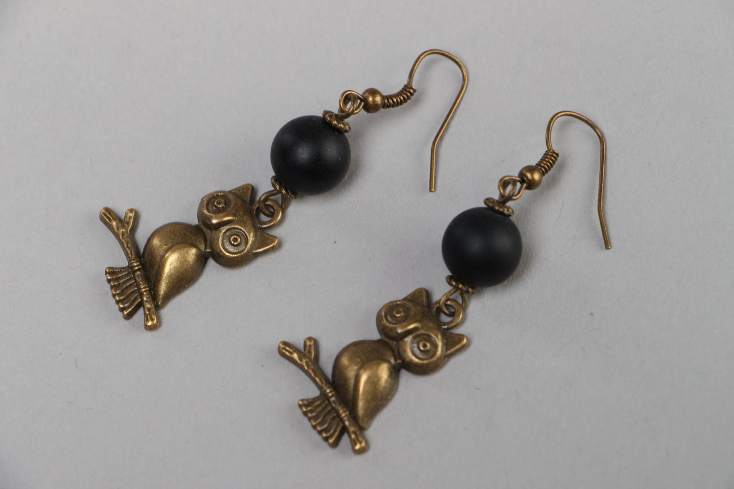Handmade dangle earrings with shungite beads and metal charms in the shape of owls photo 1