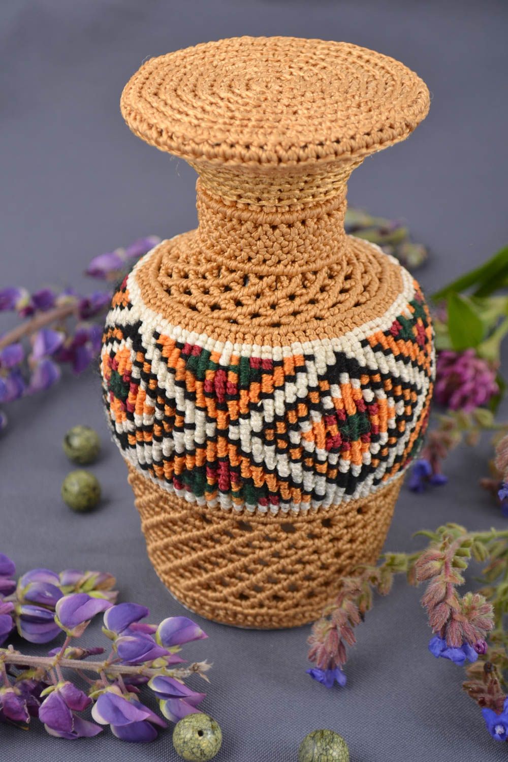 Handmade decorative glass bottle woven over with threads using macrame technique photo 1