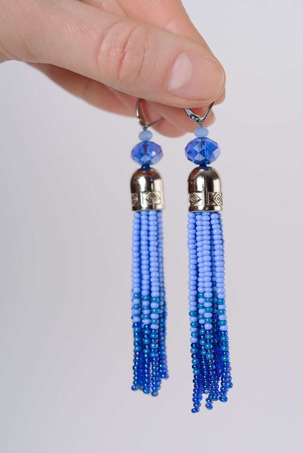 Beautiful women's handmade dangle beaded earrings in blue color palette photo 2