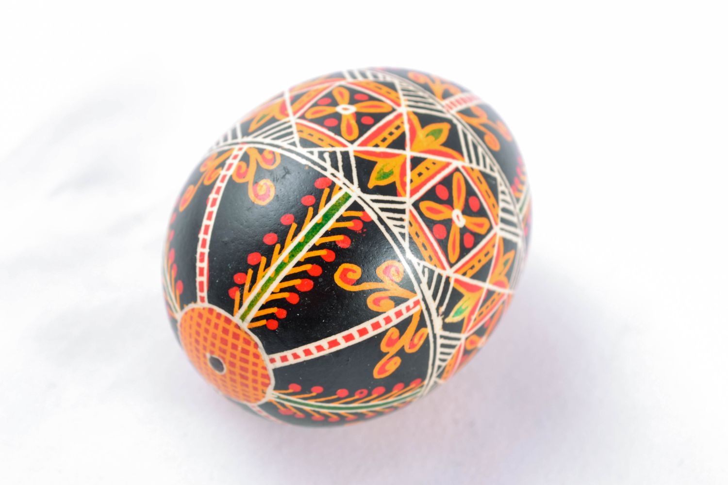 Painted chicken egg for Easter of black color with ornament photo 3