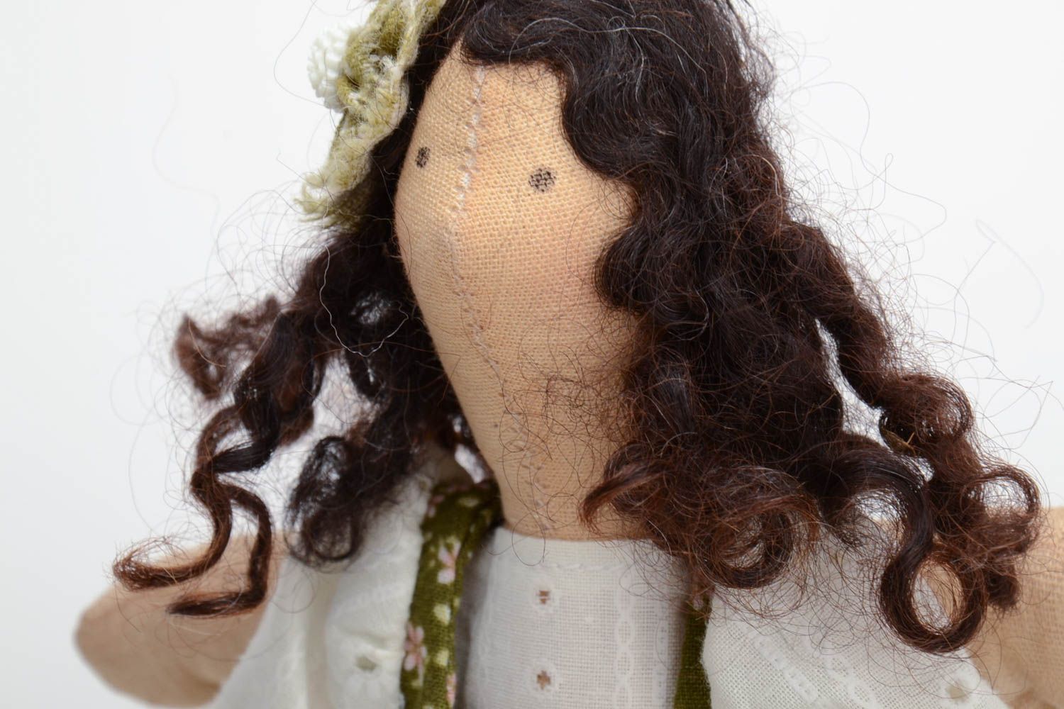 Handmade soft doll sewn of natural fabrics with curly hair in green dress photo 3