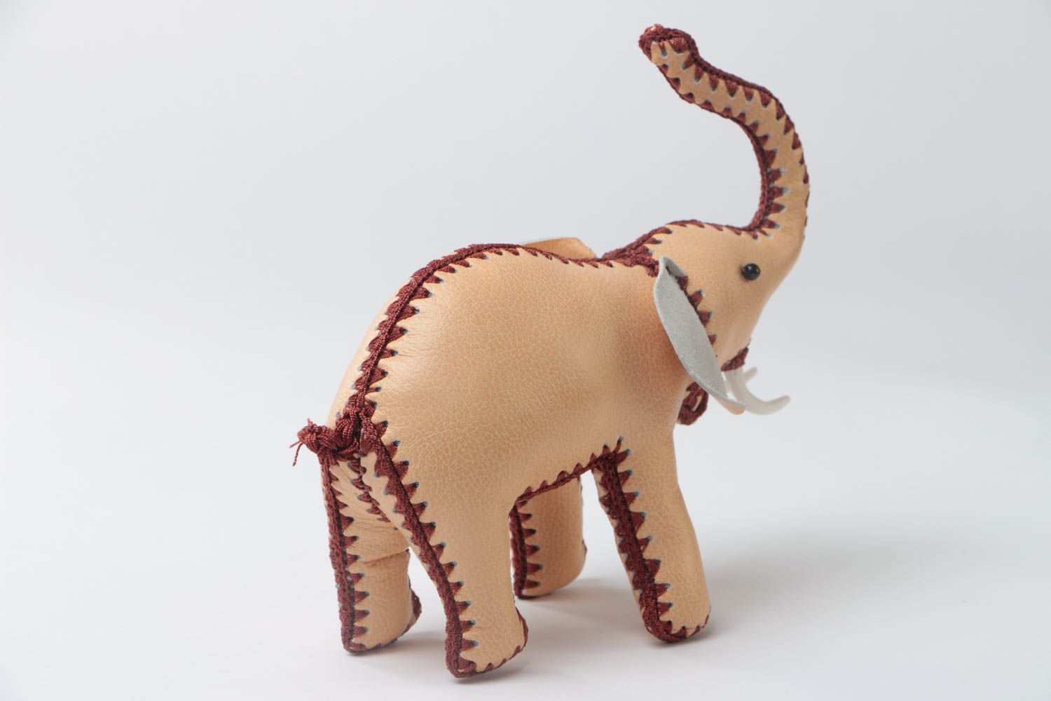 Handmade designer small soft toy elephant sewn of genuine leather of beige color photo 4