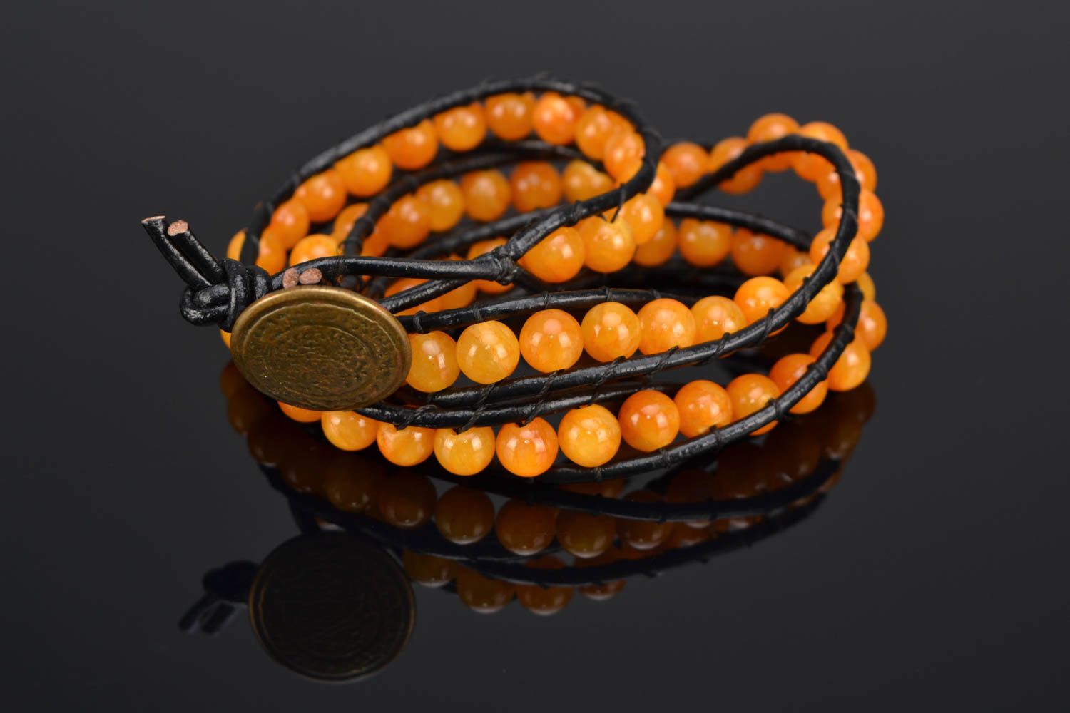 Orange leather beaded bracelet in three rows photo 1
