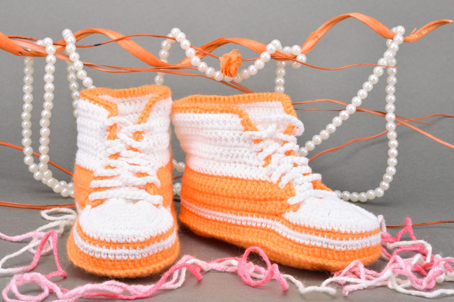 Handmade crocheted small orange and white baby shoes with shoelaces photo 1