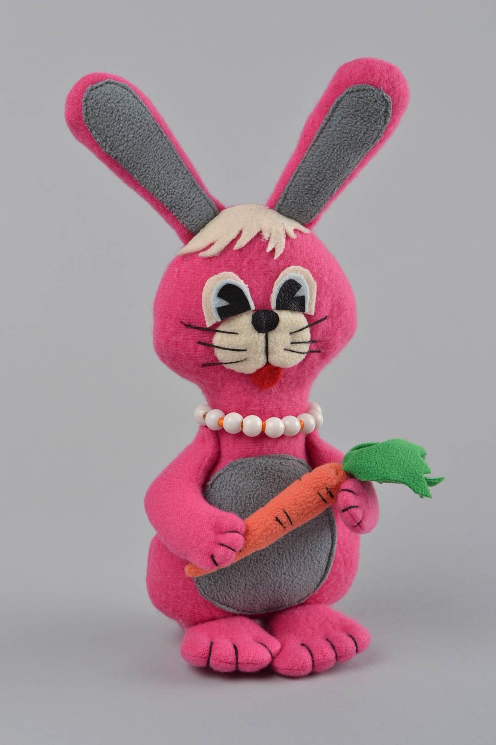 Handmade designer small soft toy sewn of fleece pink rabbit with carrot photo 1