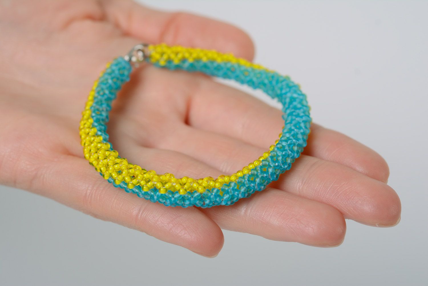 Thin handmade wrist bracelet woven of yellow and blue beads in Ukrainian style photo 2