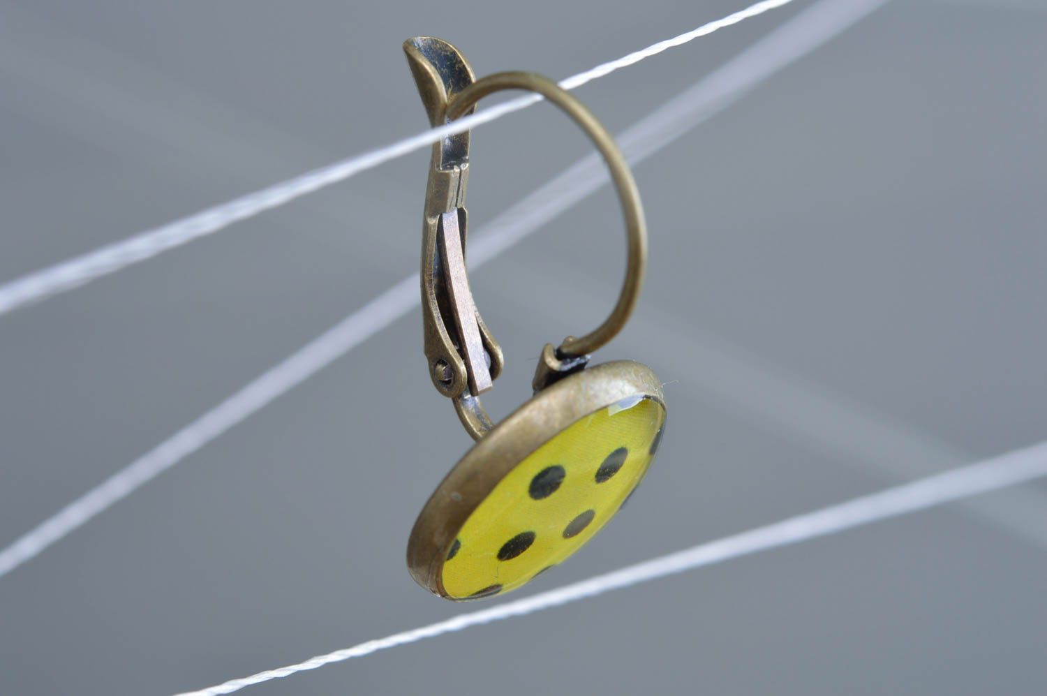Handmade designer decoupage epoxy earrings of yellow color with black dots photo 2
