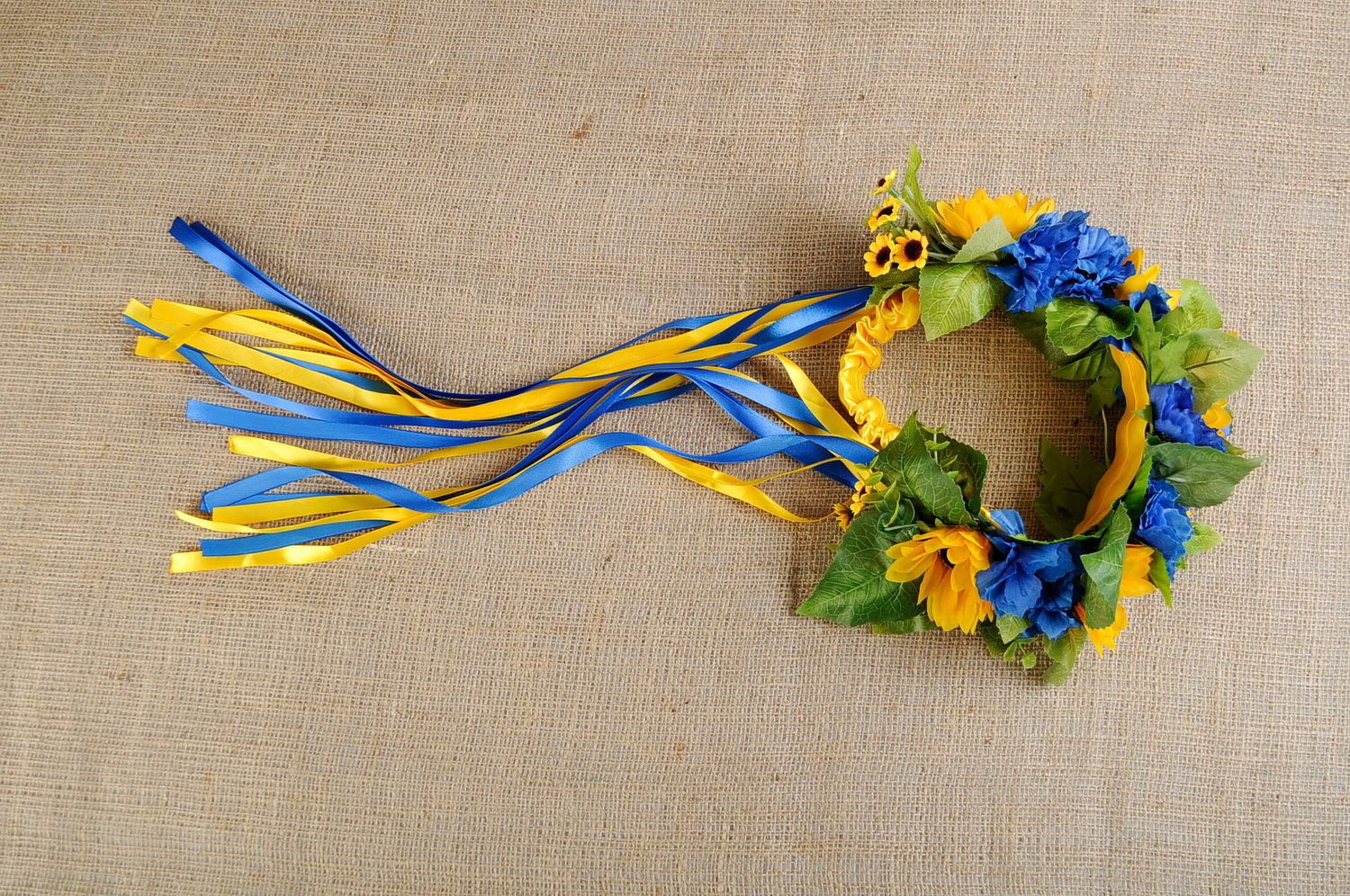 Wreath with artificial flowers and thin ribbons photo 3