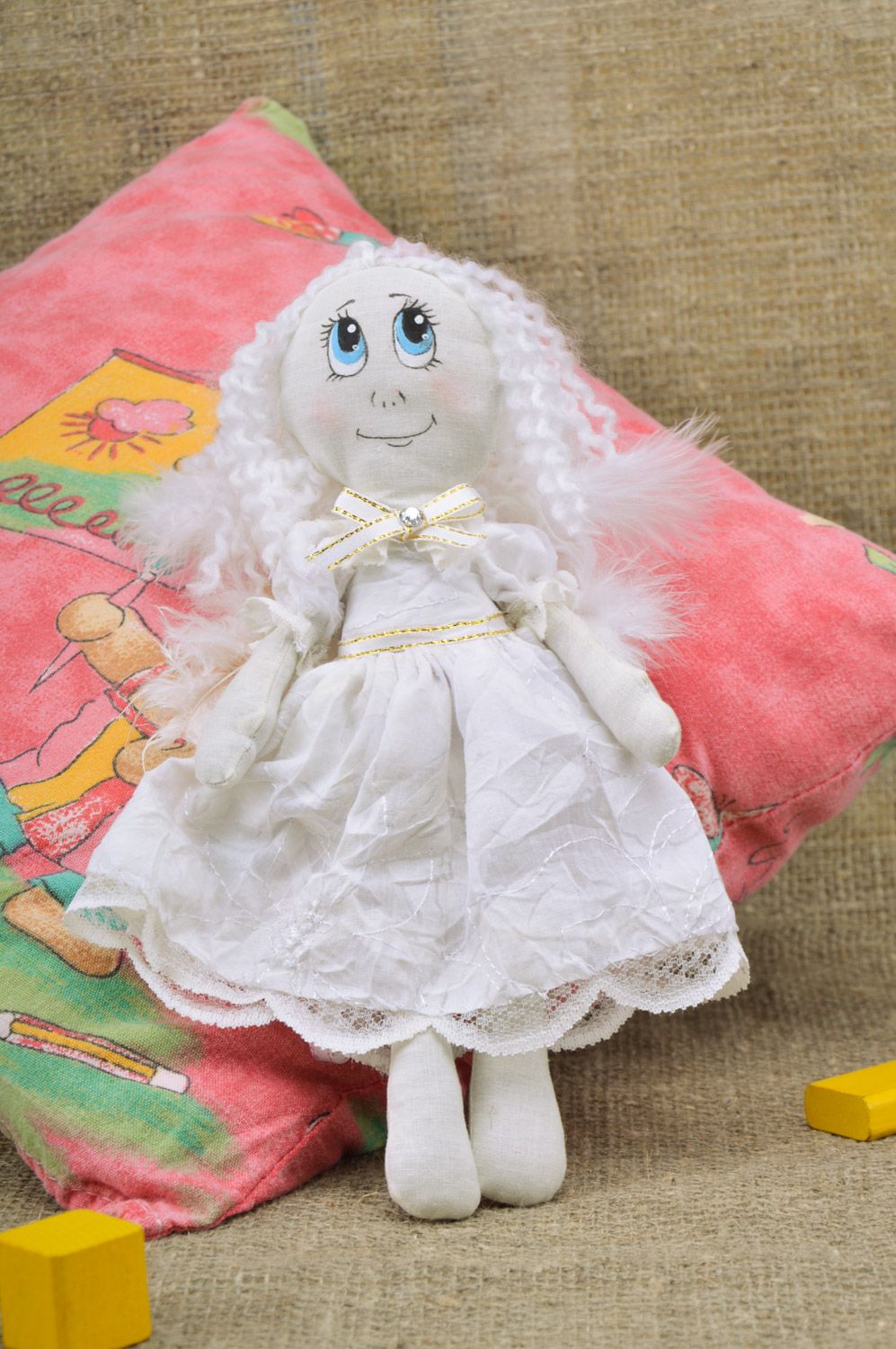 Handmade white fabric soft doll of average size with wings made of feathers photo 1
