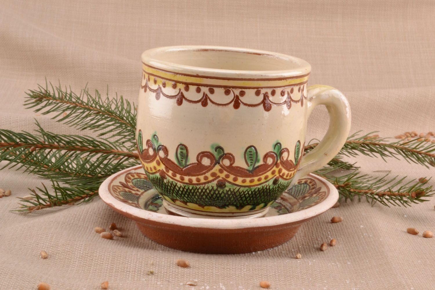 Decorative glazed coffee cup with handle, saucer in Ukrainian green and brown pattern photo 1