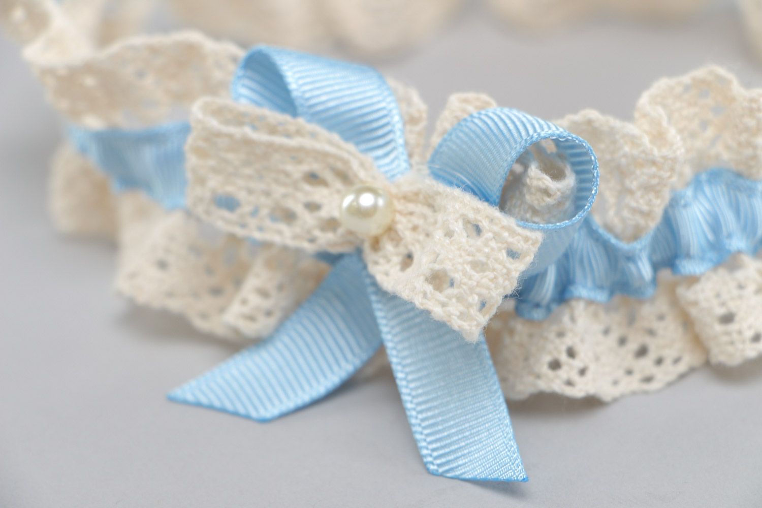 Handmade ivory colored lace bridal garter with tender blue ribbon and pearls photo 4