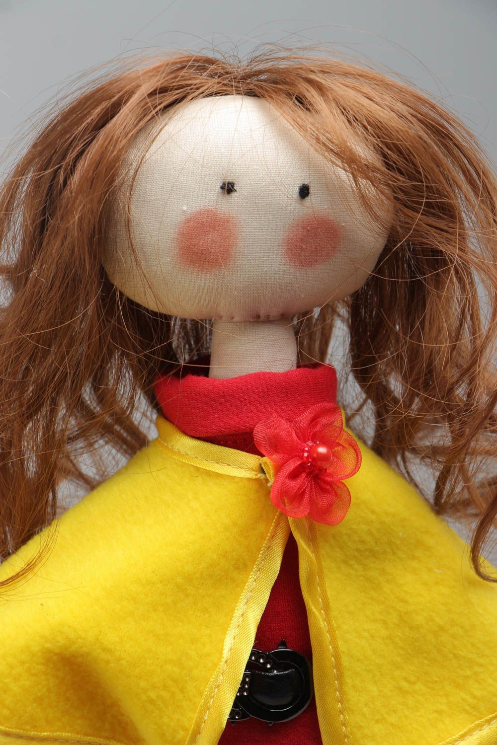 Handmade soft doll sewn of cotton fabric in yellow coat and shoes for children photo 3