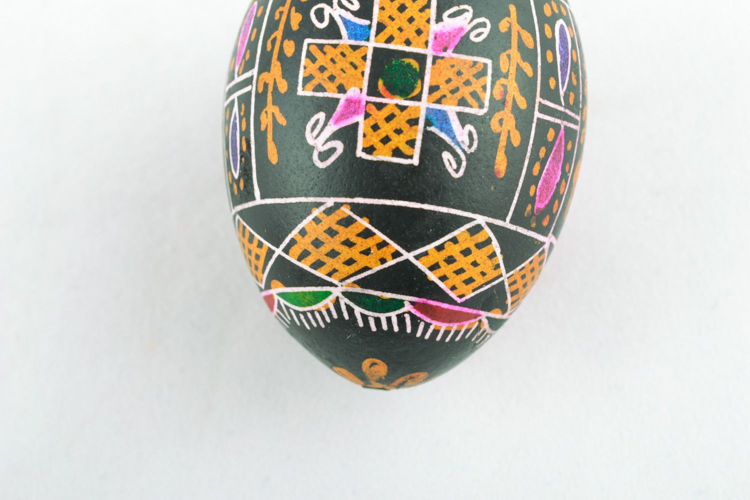 Handmade collectible Easter egg with traditional wax painting on black background photo 4