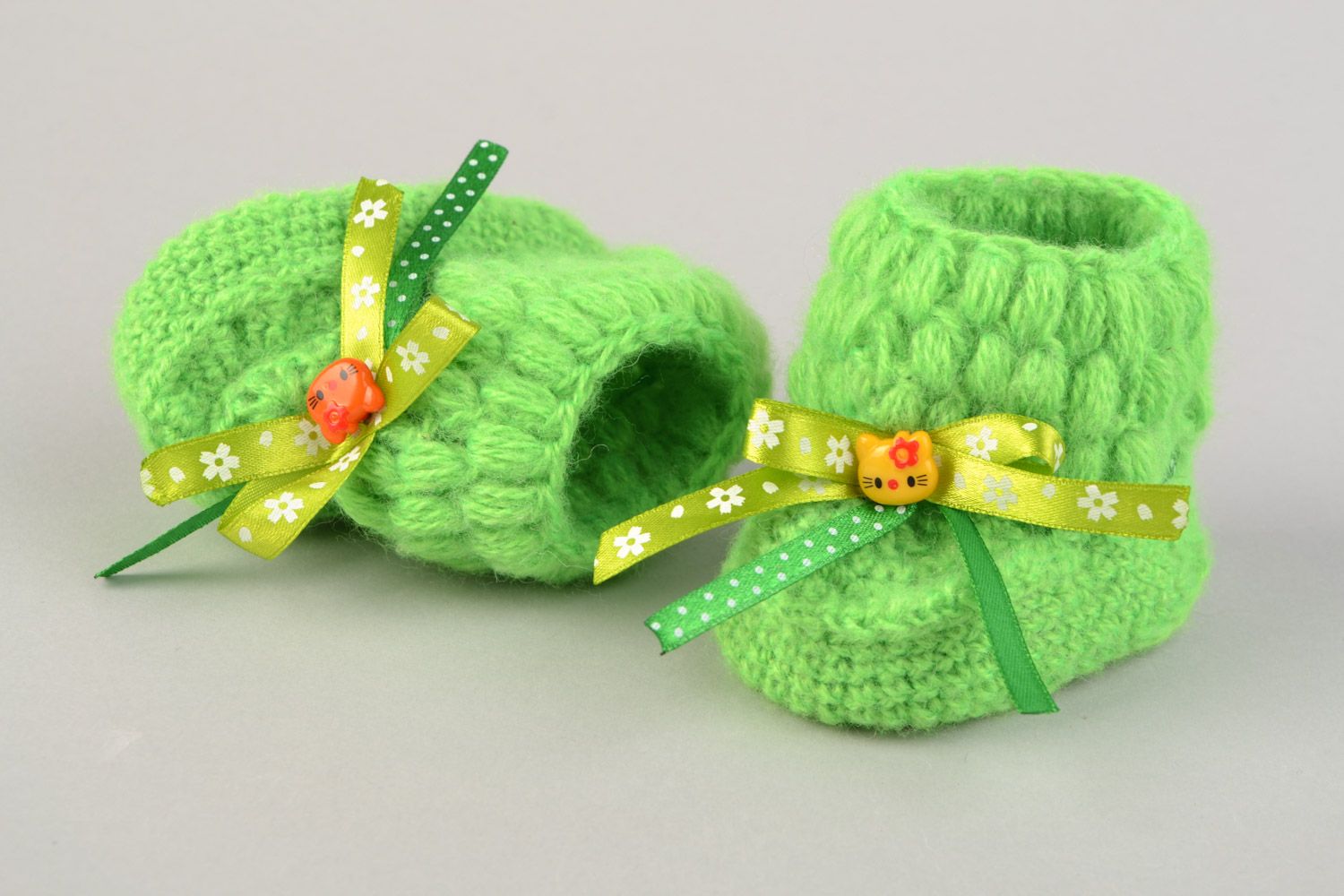 Handmade beautiful little crocheted booties for a baby girl with green bows  photo 1