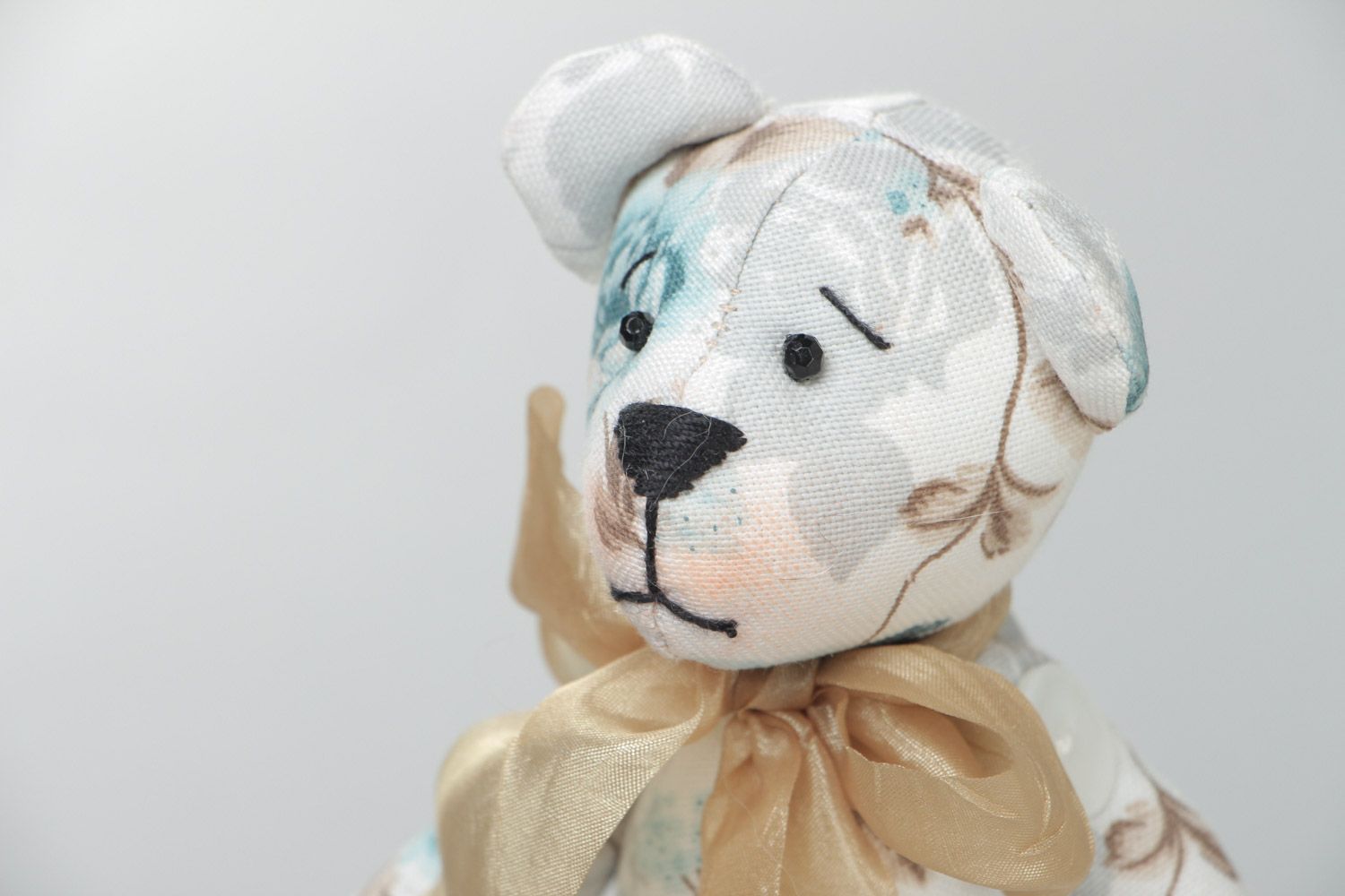 Handmade cute soft toy sewn of cotton Bear with bow in tender color palette photo 3