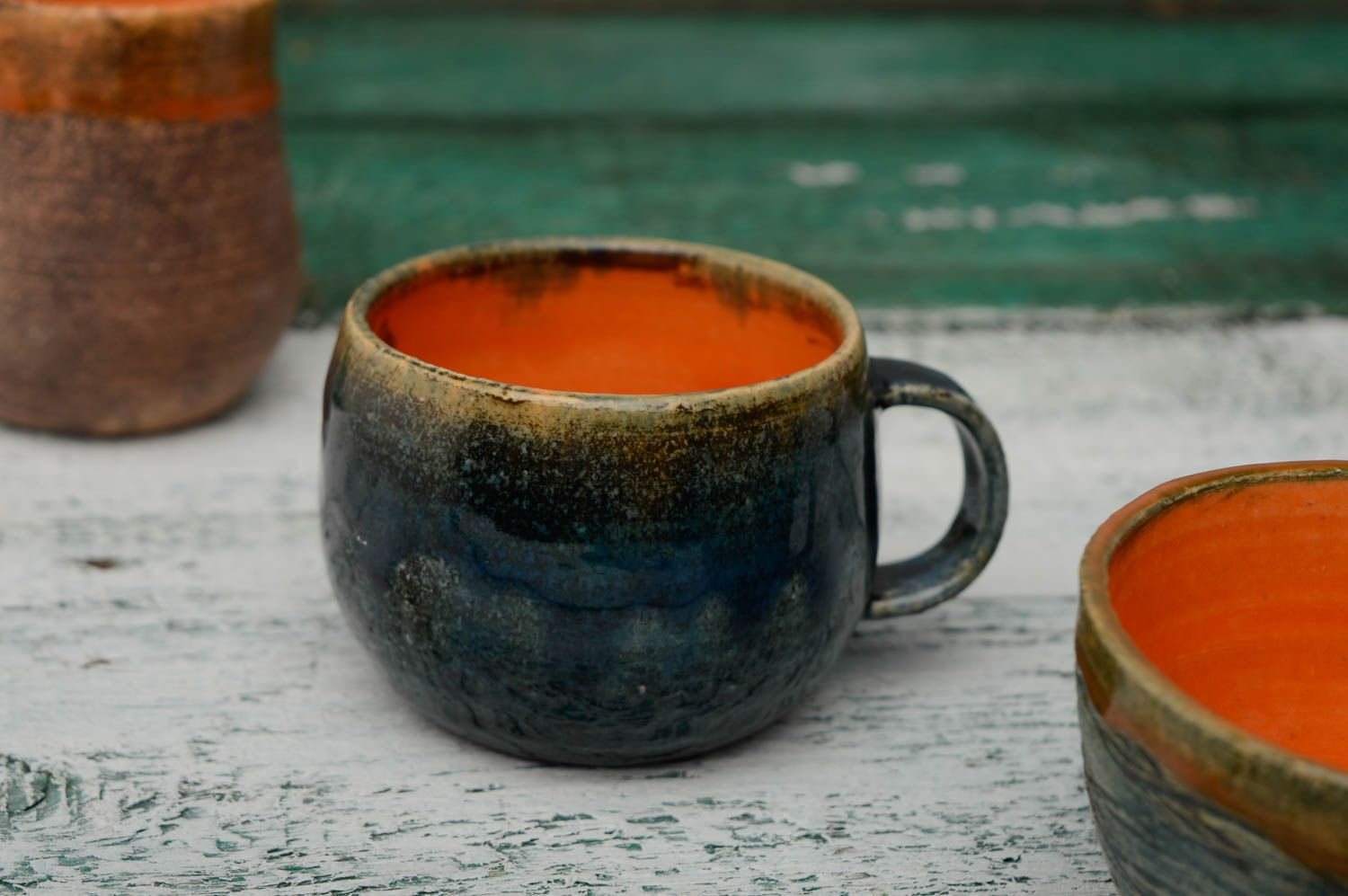 Glazed ceramic handmade coffee cup in deep blue and orange color with handle photo 1