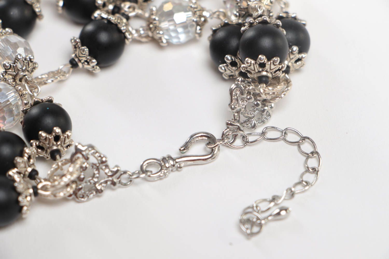 Three-layer beaded gemstone bracelet with black beads and metal charms photo 3