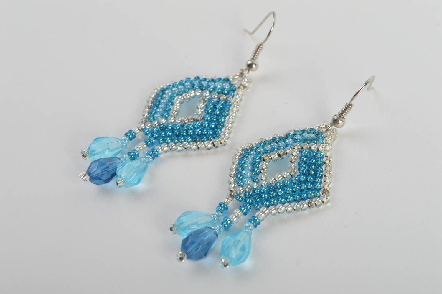 Handmade bead woven dangle earrings in the shape of rhombus of light blue color photo 3